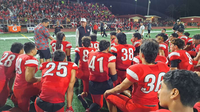 Head Kahuku coach Sterling Carvalho addresses his team following the Red Raiders' 30-23 win over St. John Bosco. Photo: Heston Quan.